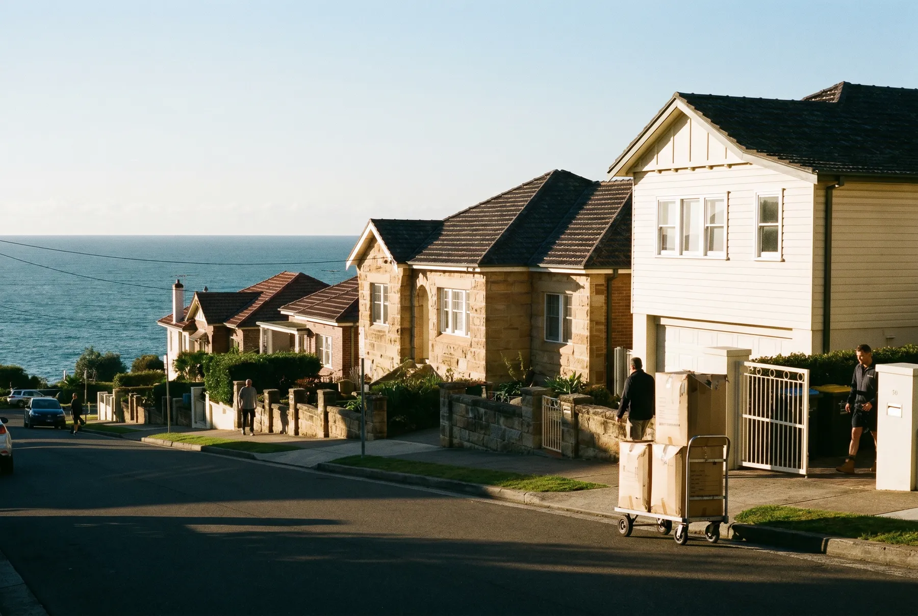A clifftop street of houses in Dover Heights with the ocean horizon beyond