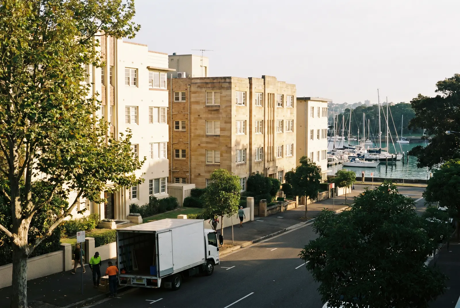 Harbourfront apartment buildings in Rose Bay with moored yachts beyond
